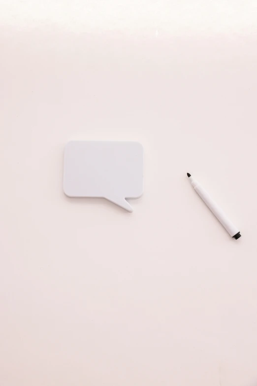 a laptop computer sitting on top of a white desk, speech bubbles, pencil, minimalist photorealist, white pearlescent