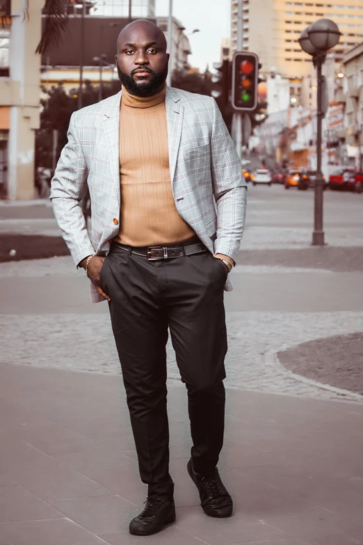 a man standing in the middle of a city street, trending on pexels, renaissance, wearing tight suit, half body cropping, pastel', brown skin