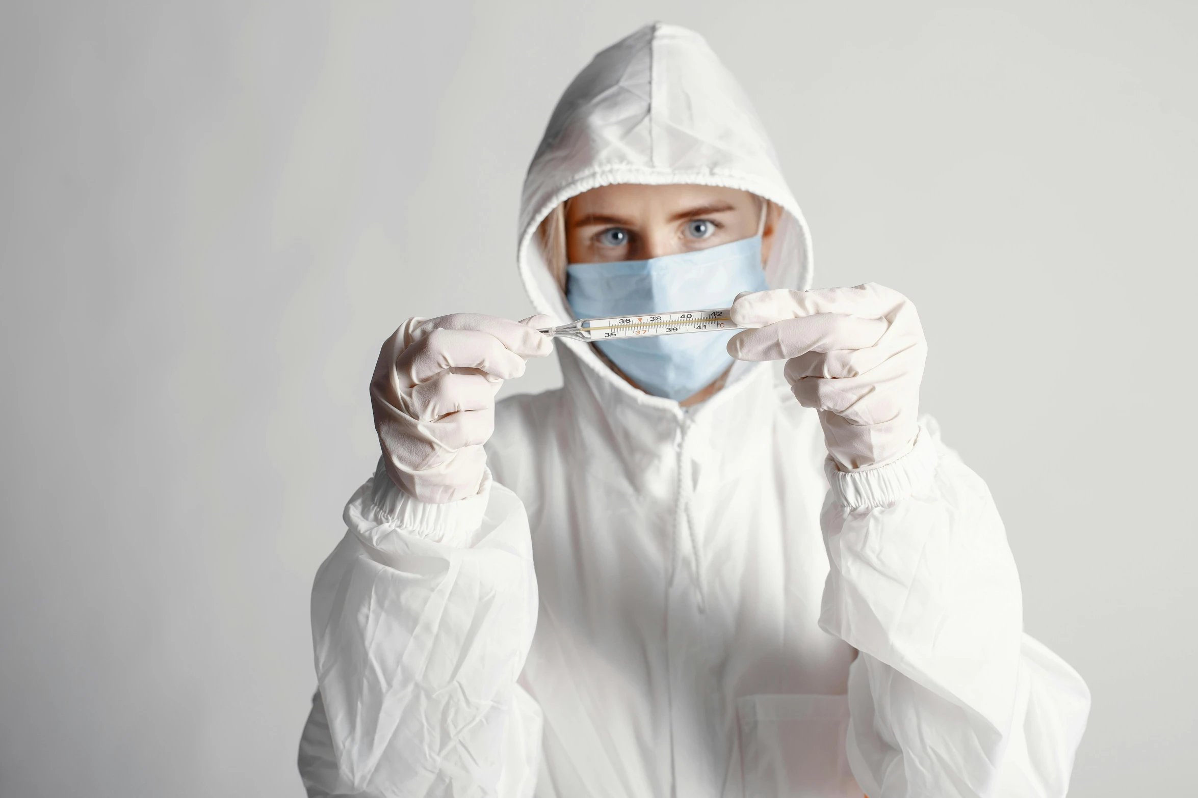 a person wearing a protective suit and gloves, an album cover, pexels contest winner, syringe, white clothing, concentration, avatar image