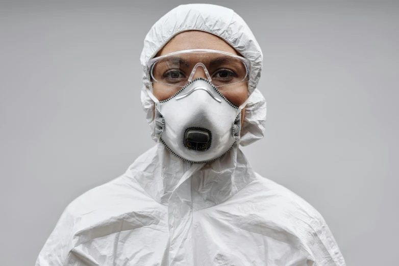 a man wearing a protective suit and goggles, an album cover, pexels contest winner, hyperrealism, white uniform, portrait n - 9, hazmat, modest