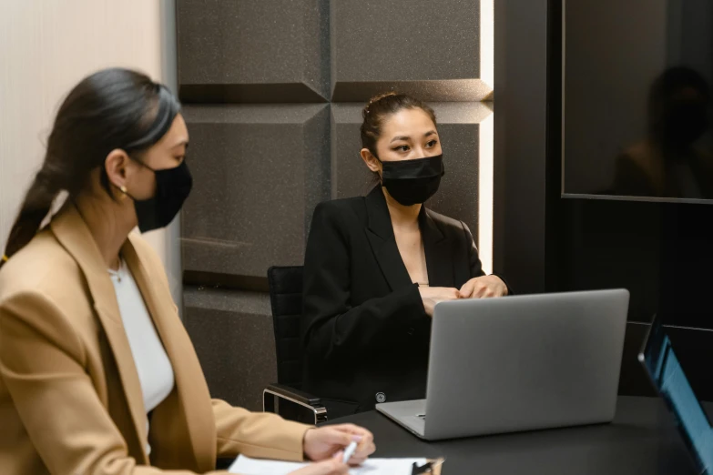 two women sitting at a table with a laptop, trending on pexels, wearing all black mempo mask, in a meeting room, avatar image, asian female