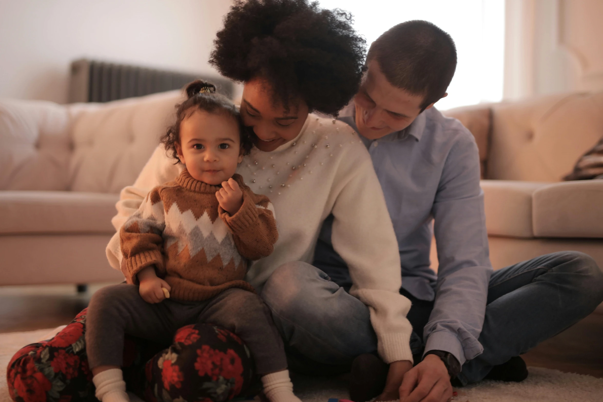 a woman and two children are sitting on the floor, pexels, mixed race, 1 2 9 7, father with child, cozy