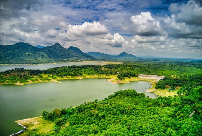 a large body of water surrounded by trees, by Tom Wänerstrand, pexels contest winner, hurufiyya, sri lankan landscape, water reservoir, thumbnail, coloured photo