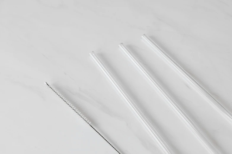 a couple of straws sitting on top of a table, polished white marble, ultraclear intricate, 3 - piece, four