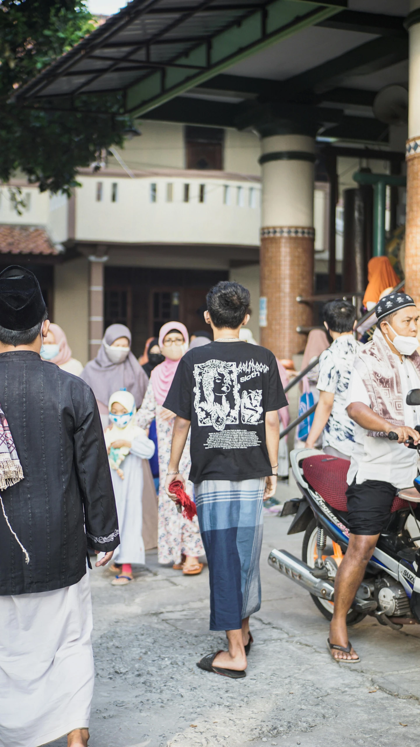 a group of people walking down a street, by Basuki Abdullah, trending on unsplash, sumatraism, batik, square, muslim, in front of the house