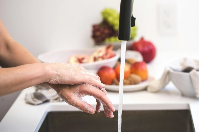 a person washing their hands in a kitchen sink, pexels, prosthetic arm, food, promo image, clean face and body skin