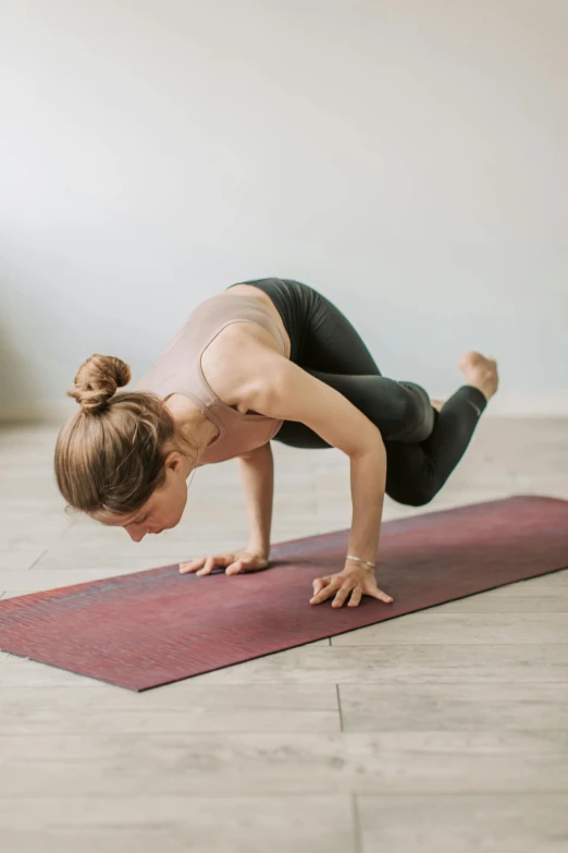 a woman doing a yoga pose on a yoga mat, maroon, 🦩🪐🐞👩🏻🦳, as well as scratches, bixbite