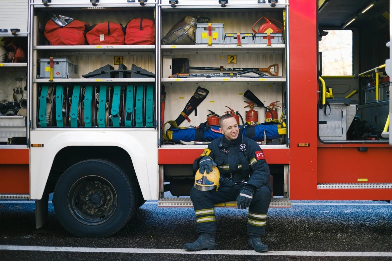 a fireman sitting in front of a fire truck, a photo, pexels contest winner, arbeitsrat für kunst, first aid kit, wearing plumber uniform, 🚿🗝📝