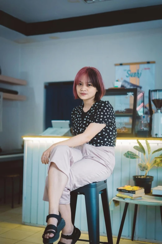 a woman sitting on a stool in a kitchen, a picture, inspired by Ni Yuanlu, pexels contest winner, cute girl with short pink hair, in a coffee shop, portait photo profile picture, square