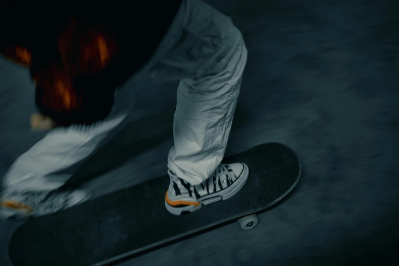 a close up of a person riding a skateboard, by Adam Marczyński, pexels contest winner, hyperrealism, orange grey white, night time footage, wearing white sneakers, motion graphic