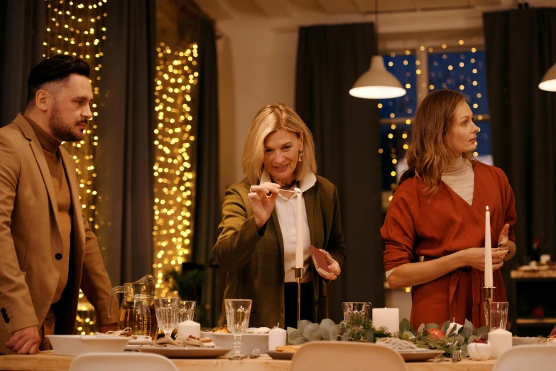 a group of people standing around a dinner table, decorations, profile image, holiday vibe, brown