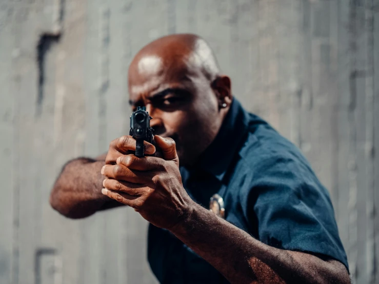 a man pointing a gun at the camera, pexels contest winner, dave chappelle, profile photography, police officer hit, portrait shot 8 k