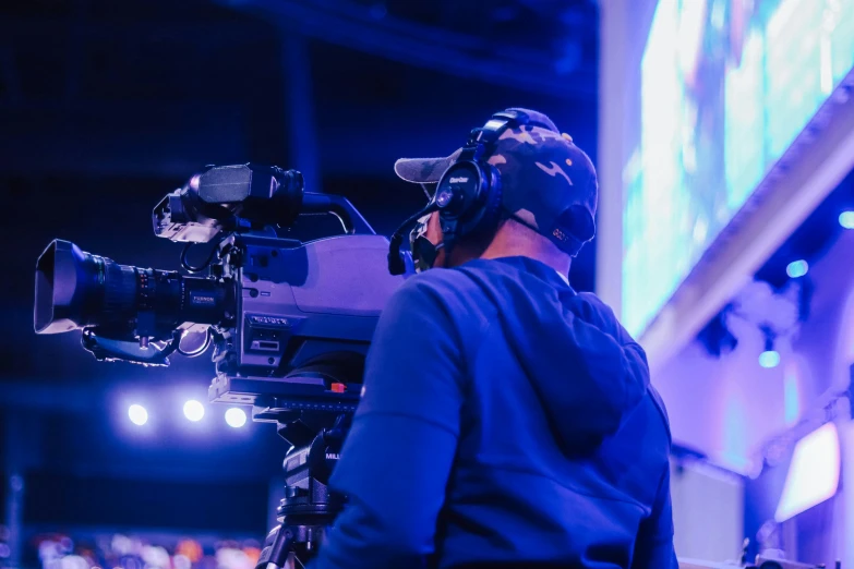 a man that is standing in front of a camera, happening, esports, facing away from the camera, uncropped, television head