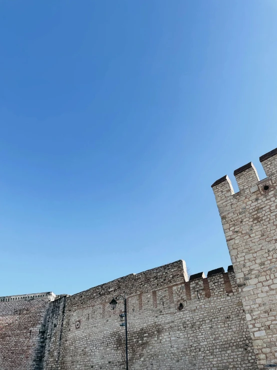 a clock tower sitting on the side of a brick building, castles floating in mid air, from italica, clear blue skies, thumbnail