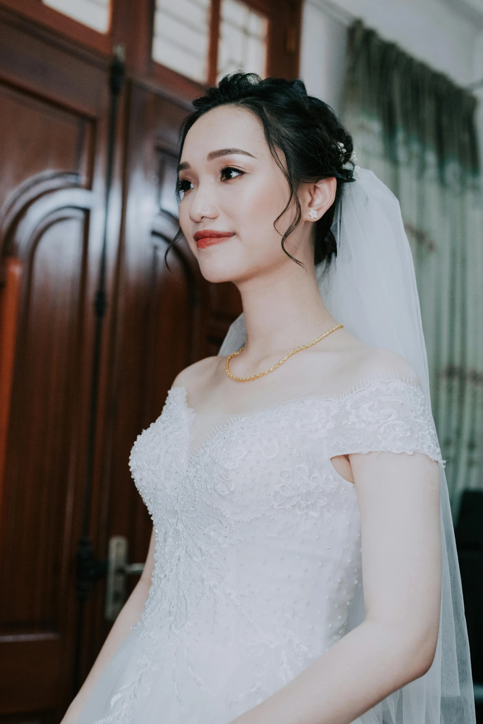 a woman in a wedding dress standing in front of a door, inspired by Ruth Jên, pexels contest winner, photorealism, vietnamese woman, thick jawline, gif, low quality photograph