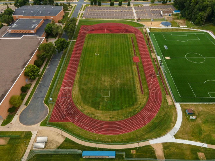 an aerial view of a soccer field, by Josh Bayer, athletic crossfit build, taken in 2022, from wheaton illinois, highschool background