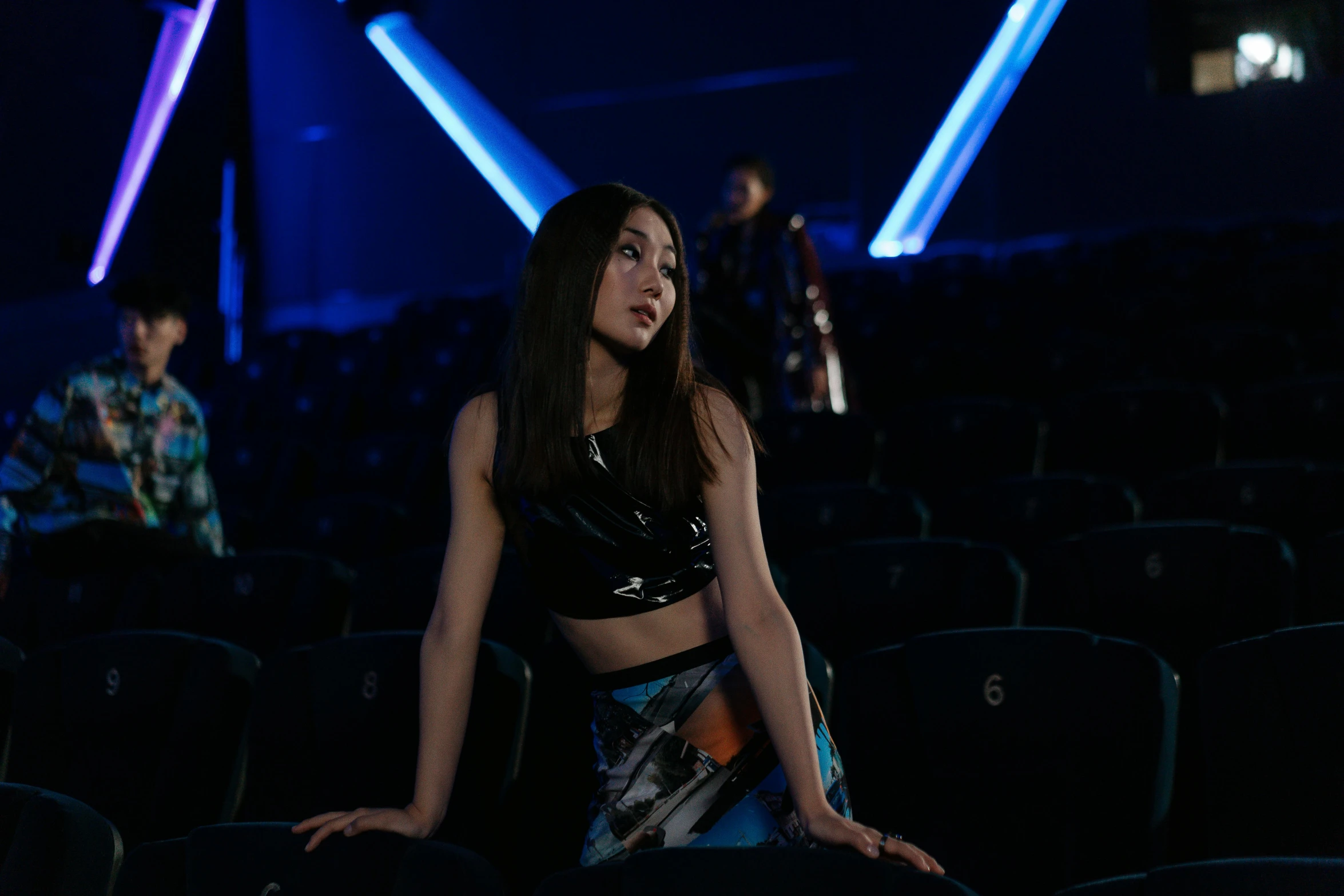 a woman sitting on top of a chair in a theater, an album cover, by Julia Pishtar, pexels contest winner, holography, gemma chan beautiful girl, cai xukun, physical : tinyest midriff ever, star trek asian woman