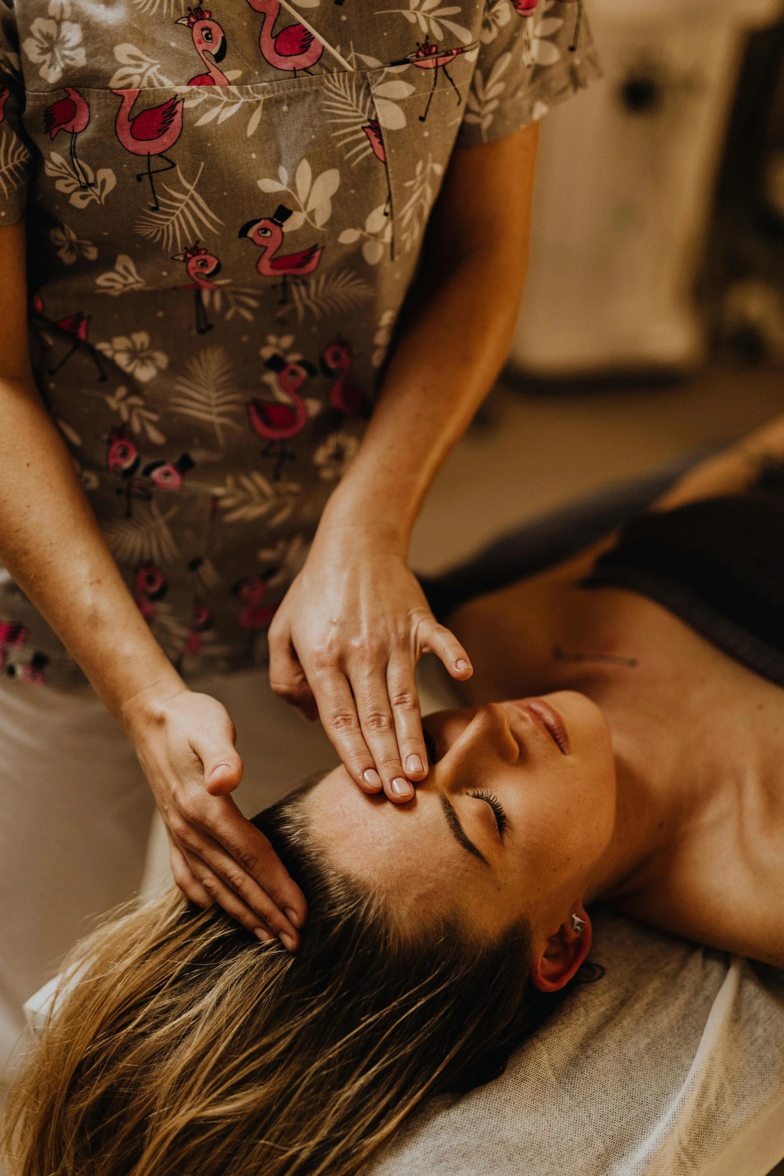 a woman getting a massage at a spa, a portrait, by Daniel Lieske, unsplash, gemstone forehead, straya, foil, buzzed hair on temple