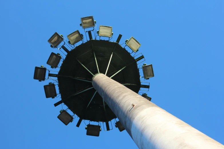 a tall pole with lights on top of it, inspired by Alexander Rodchenko, pexels contest winner, carousel, blue sky, sitting down, giant speakers