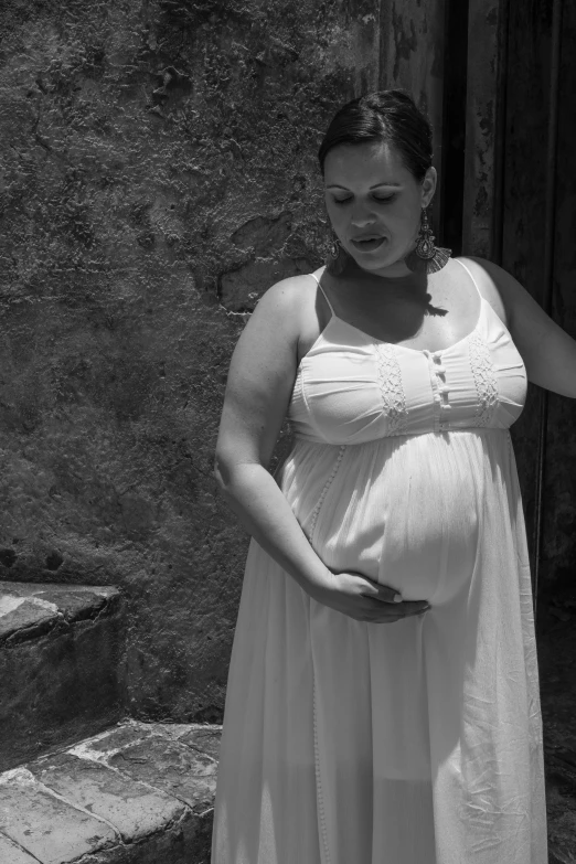 a black and white photo of a pregnant woman, flickr, happening, traditional corsican, epk, wearing a cute white dress, video