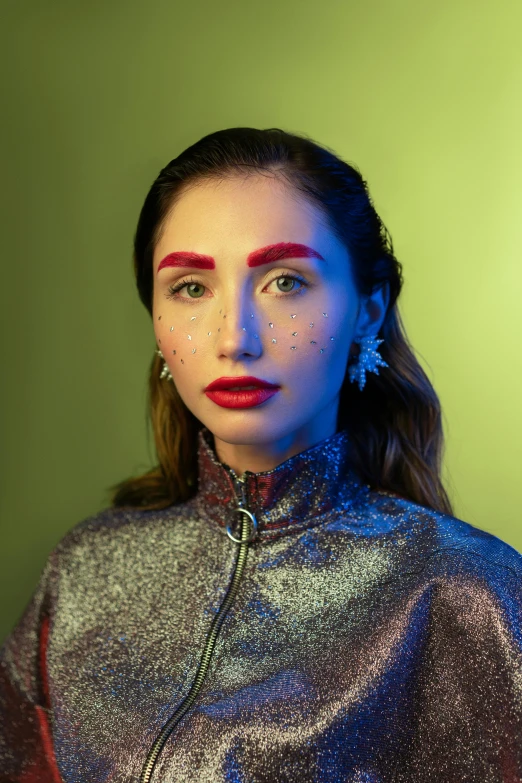 a woman wearing a silver jacket and red lipstick, an album cover, inspired by Julia Pishtar, trending on pexels, big eyebrows, as a starfleet officer, mahira khan as a d&d wizard, color studio portrait