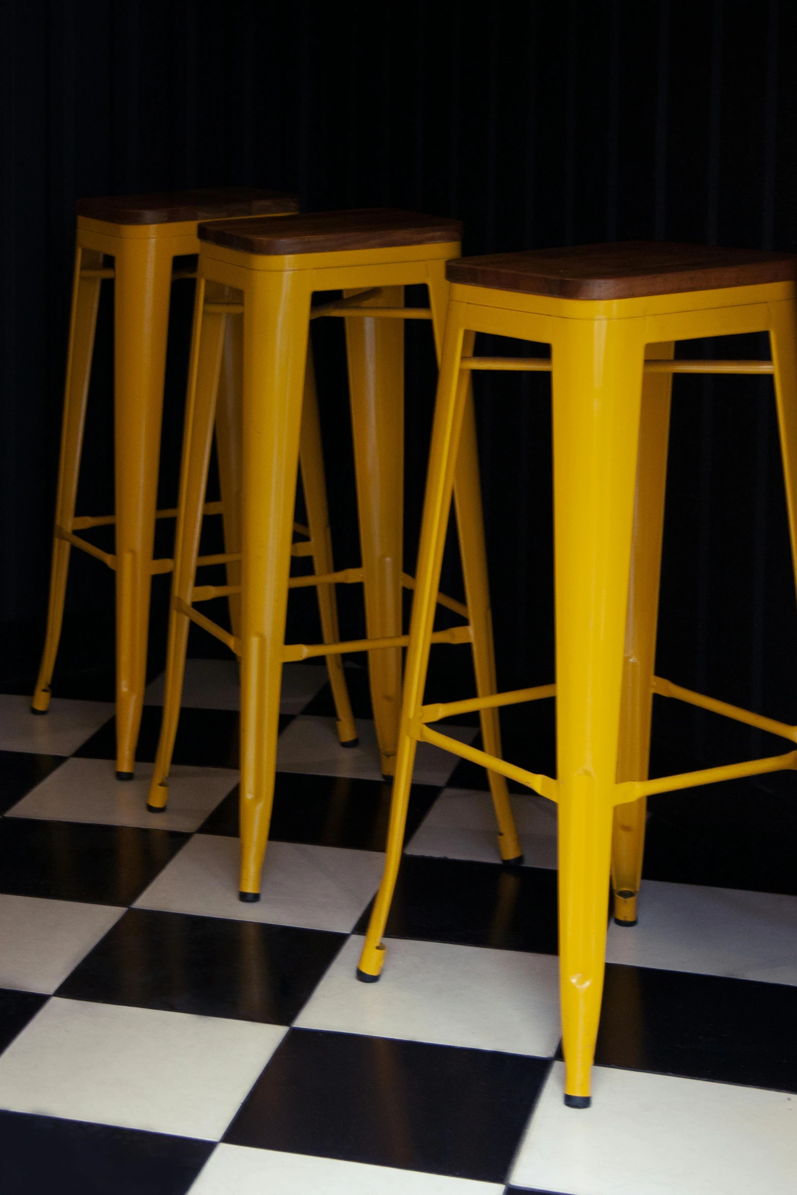 a group of yellow stools sitting on top of a checkered floor, caulfield, 15081959 21121991 01012000 4k, bar, square