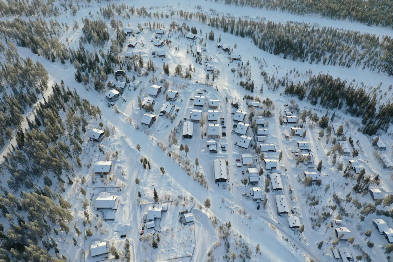 an aerial view of a small town in the woods, by Anton Lehmden, hurufiyya, winter photograph, nina tryggvadottir, ap, inuk