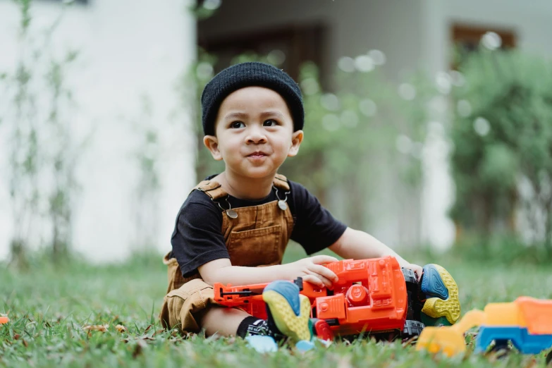 a little boy sitting in the grass with a toy truck, pexels contest winner, engineer, avatar image, attractive and good looking, thumbnail