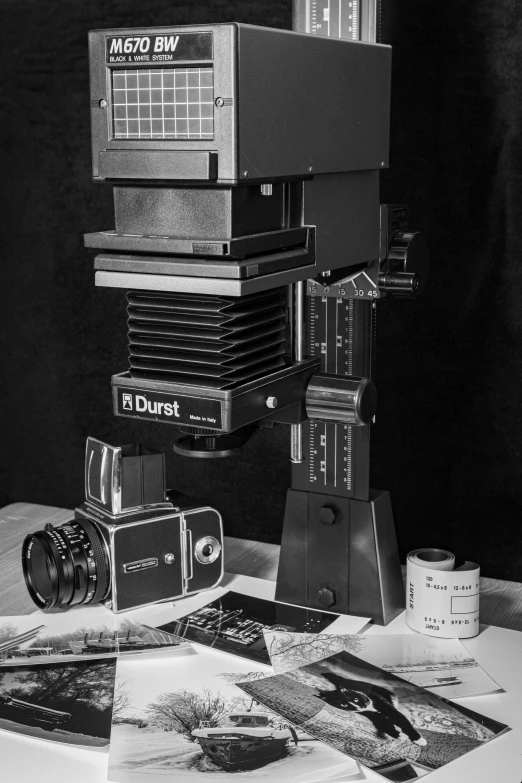 a couple of cameras sitting on top of a table, a black and white photo, hyperrealism, scientific instruments, stacked image, ansel ], miscellaneous objects