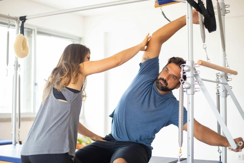 a man and a woman doing a pilates exercise, a picture, by Meredith Dillman, trending on unsplash, square, sydney, injured, “ iron bark