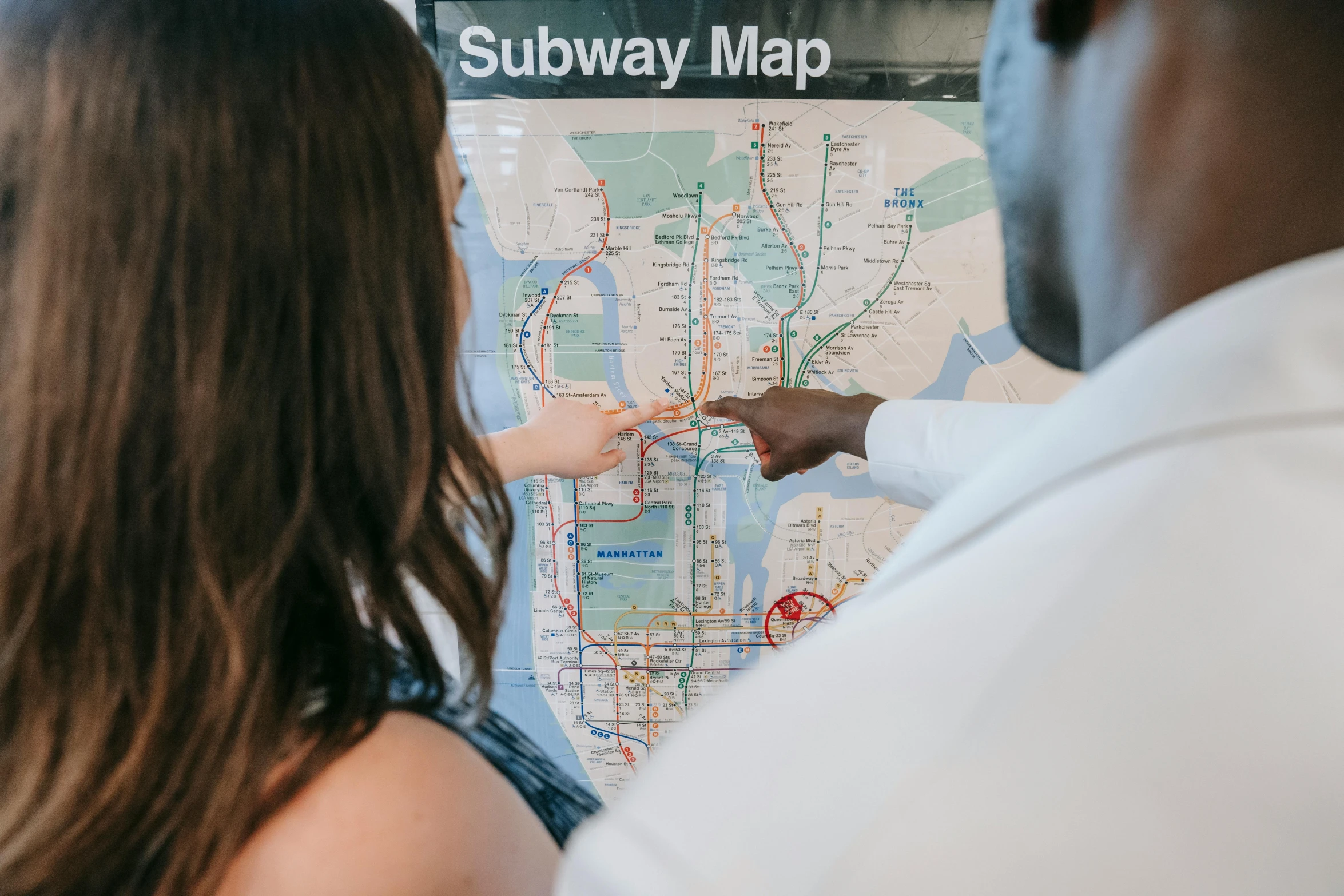 a man and a woman looking at a subway map, trending on unsplash, fan favorite, ny, diverse, white map library