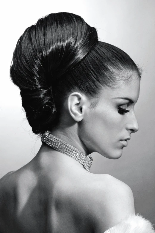 a black and white photo of a woman in a dress, inspired by Herb Ritts, !updo hair, ashley greene, hair ponytail, futuristic hairstyle