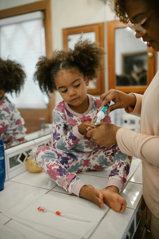 a woman brushing a child's teeth in a bathroom, african american girl, wētā fx, paul barson, high quality picture