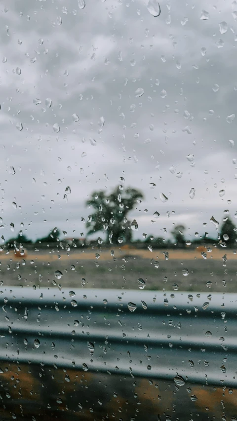 a view out the window of a car on a rainy day, an album cover, unsplash contest winner, visual art, the sky is gray, drop of waters, pixel rain, fall season