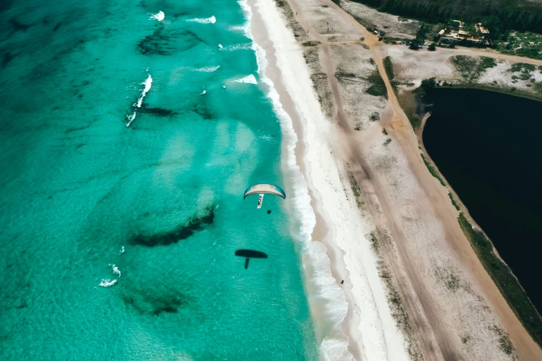 a group of people parasailing over a body of water, by Seb McKinnon, pexels contest winner, hurufiyya, overlooking the beach, satellite imagery, the emerald coast, thumbnail