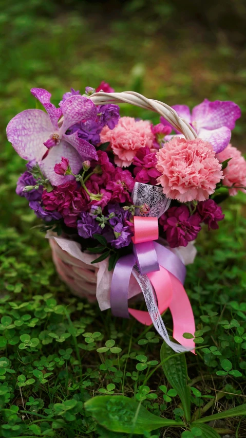 a basket filled with purple and pink flowers