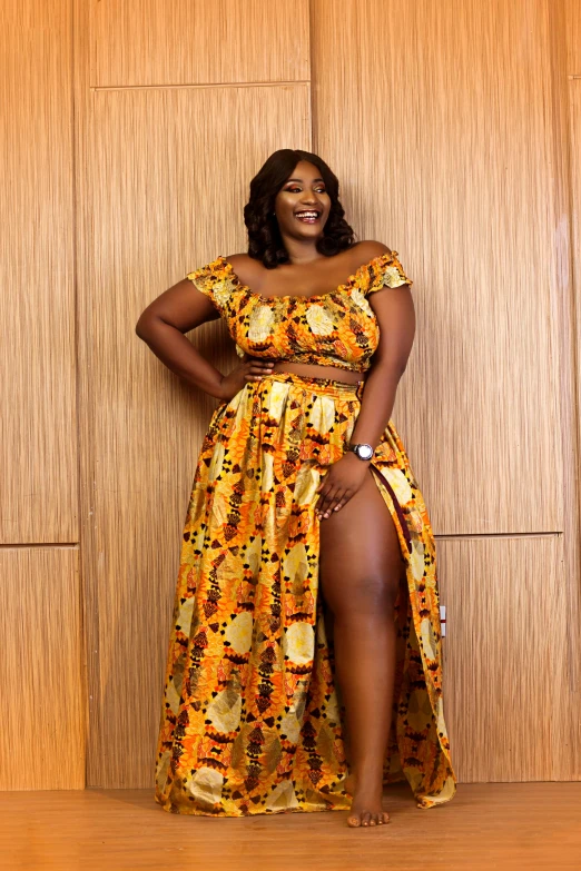 a woman standing in front of a wooden wall, an album cover, by Ella Guru, instagram, happening, wearing an african dress, plus-sized, wearing yellow croptop, thumbnail