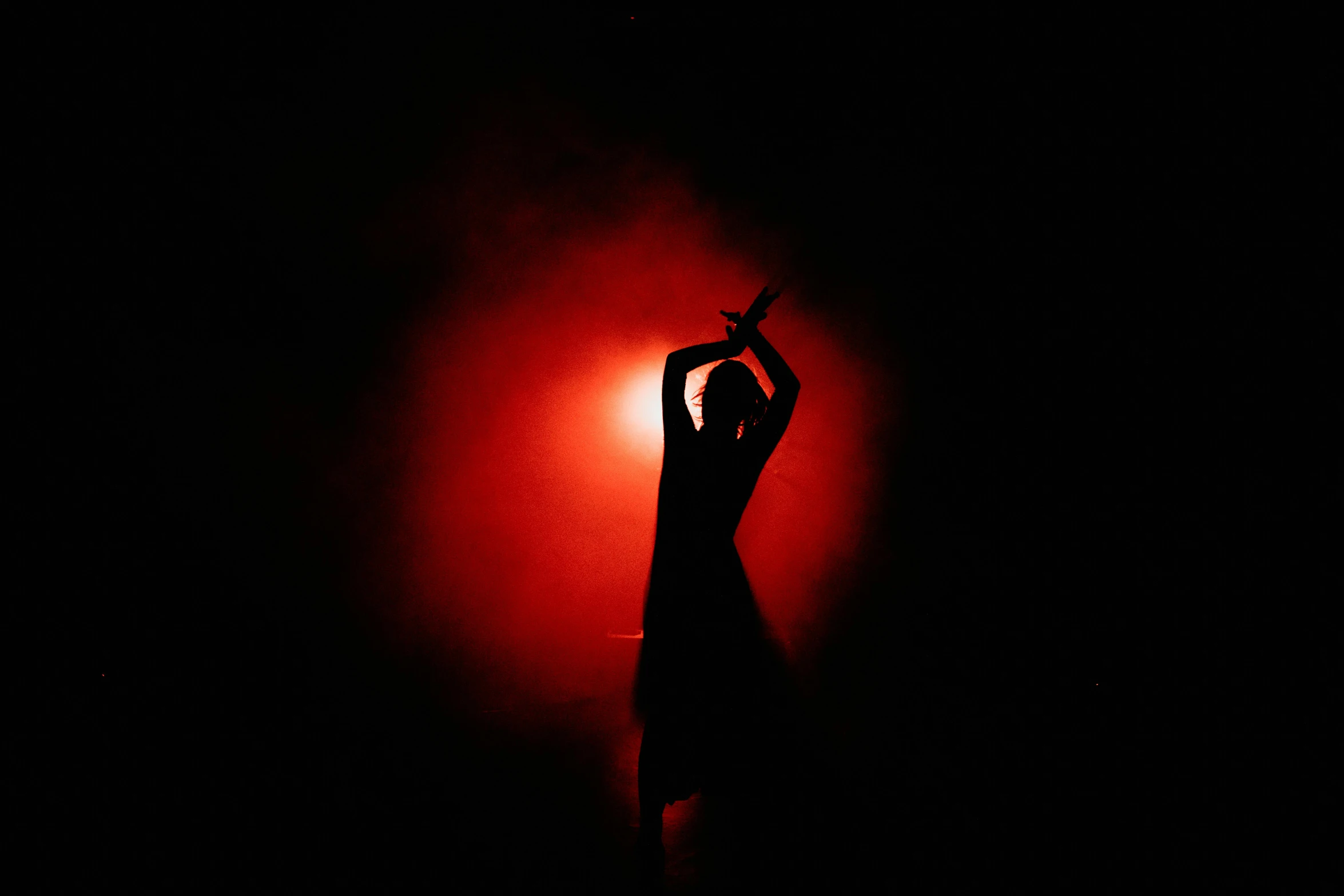 a person standing in front of a red light, arabesque, smoky lighting, dance meditation, siluettes, high quality photo