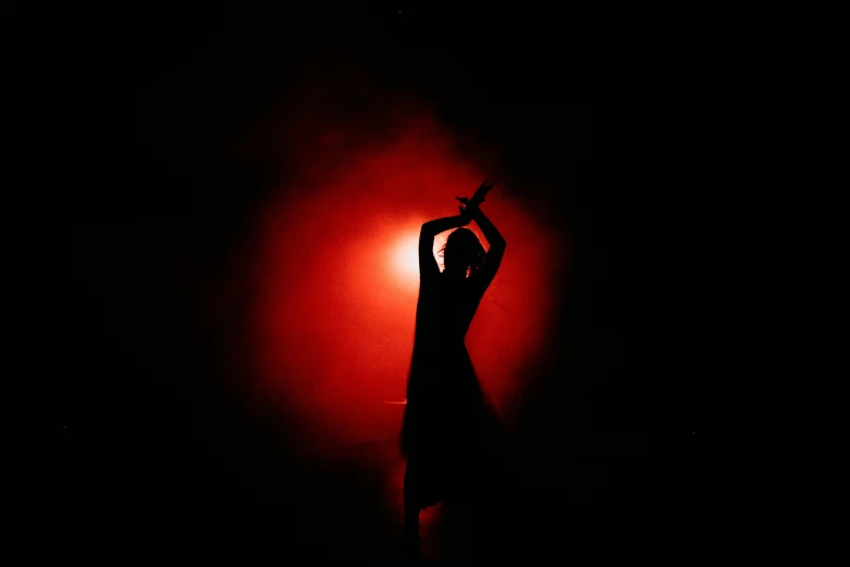 a person standing in front of a red light, arabesque, smoky lighting, dance meditation, siluettes, high quality photo