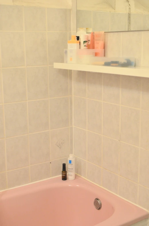 a pink bath tub sitting in a bathroom next to a mirror, an album cover, reddit, clean and organized, 2 5 6 x 2 5 6 pixels, closeup!!!!!, rainny