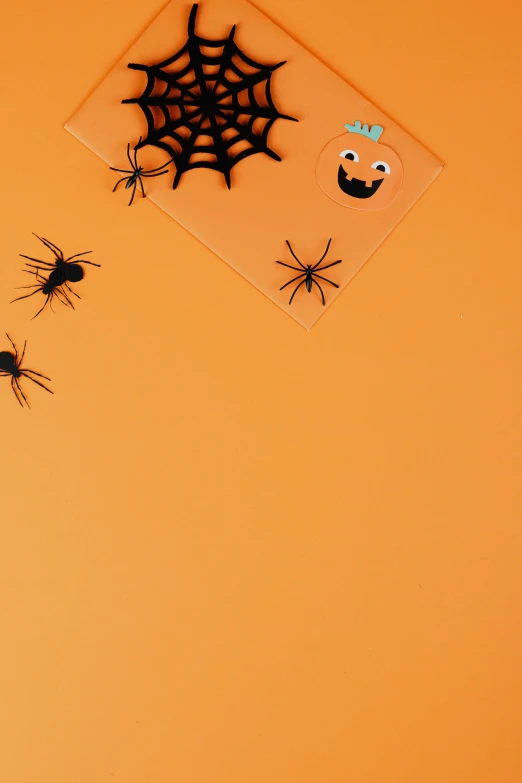 a group of halloween decorations hanging on a wall, trending on pexels, plasticien, orange backgorund, ants, rectangle, silicone patch design