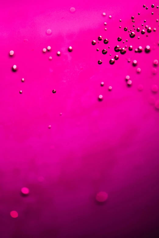 a close up of water bubbles on a pink surface, by Jacob Toorenvliet, ((pink)), champagne commercial, magenta, f / 1 1. 0