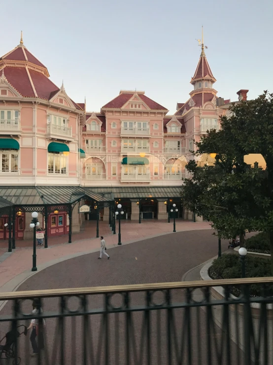 a couple of people that are standing in front of a building, inspired by disney, low quality photo, full room view, square, early in the morning