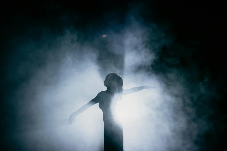 a woman that is standing in the fog, a statue, pexels contest winner, dramatic theater lighting, female dancer, silhouetted, surrounded in clouds and light