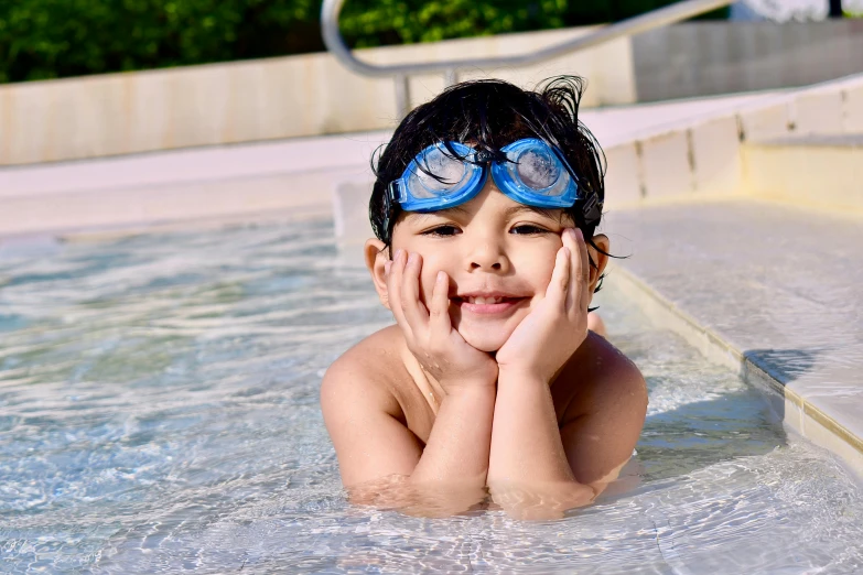 a young boy in a swimming pool wearing goggles, pixabay, thumbnail, 8 k 4 k, delightful surroundings, ayan nag