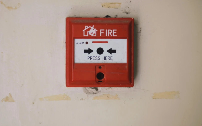 a red fire hydrant mounted to the side of a wall, by Adam Marczyński, pexels, square, controller, room is on fire, subtitles