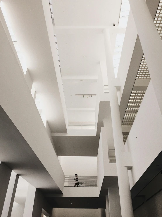 a black and white photo of the inside of a building, inspired by David Chipperfield, unsplash contest winner, light and space, in sao paulo, trending on vsco, white pale concrete city, high - angle view