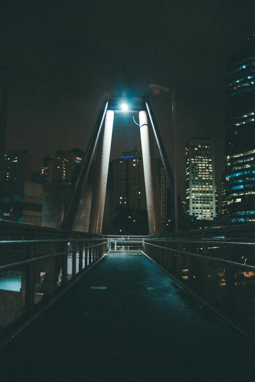 a bridge in the middle of a city at night, gaze down, in chippendale sydney, cinematic outdoor lighting, high rises