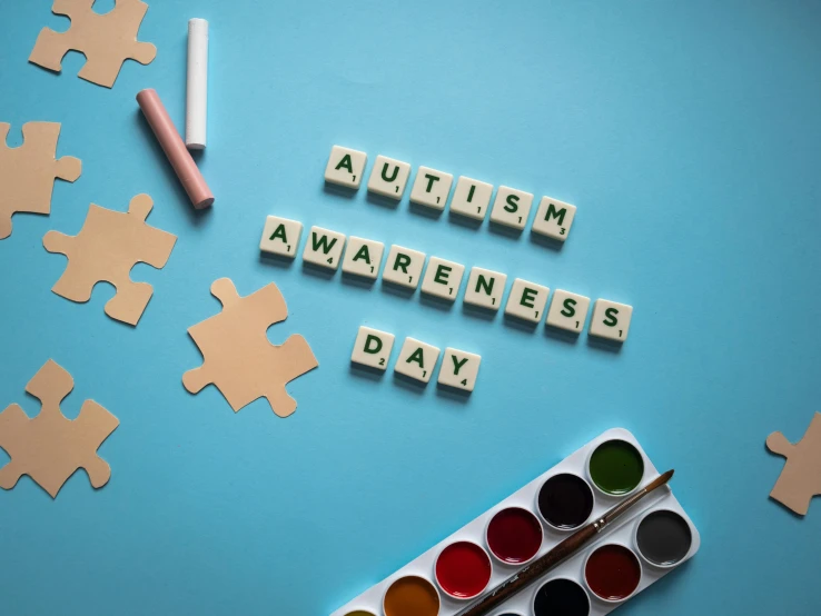 puzzle pieces with the words autism awareness day written on them, a jigsaw puzzle, by Julia Pishtar, trending on pexels, graffiti, idealised, a rubik's cube, paints, award - winning