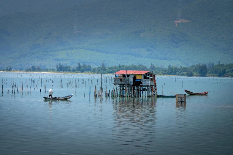 a couple of boats that are in the water, inspired by Steve McCurry, pexels contest winner, sumatraism, houses on stilts, avatar image